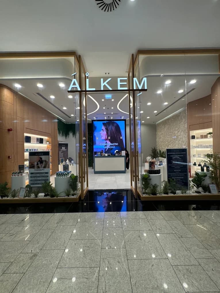 The Alkem clinic entrance, with the illuminated brand name above glass doors